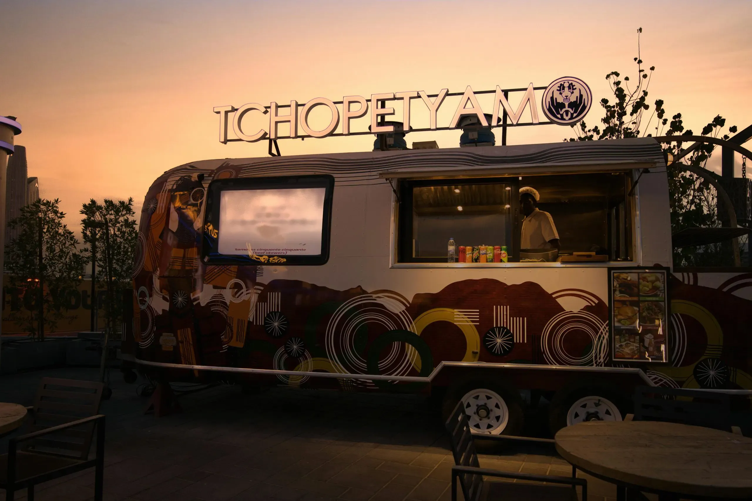 Food truck scene featuring a smiling vendor serving customers during the Food Truck Owners Expo 2025, July 15-16, at the Rio Hotel in Las Vegas, with Standard Restaurant Supply branding.